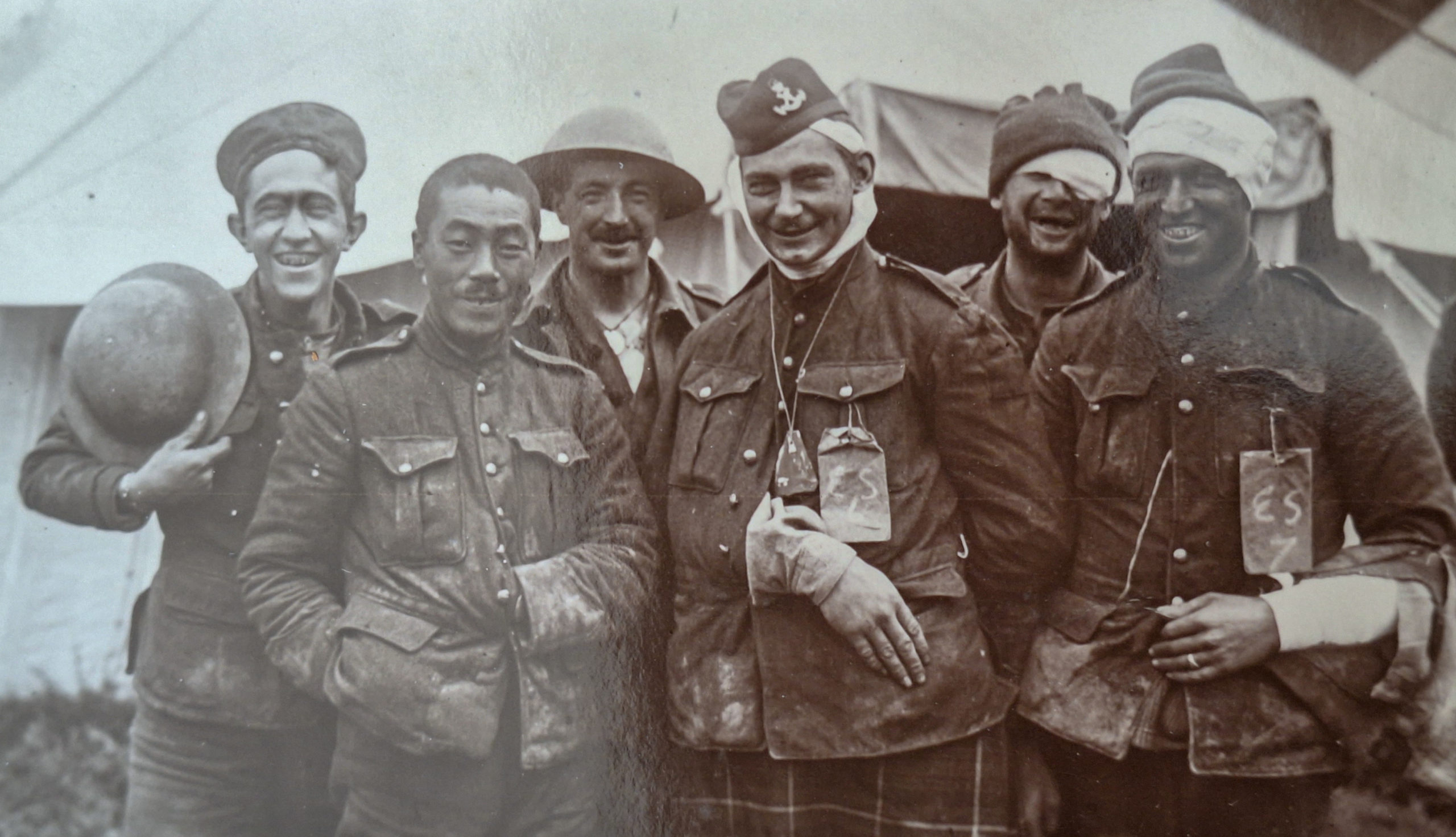 Wounded Canadian and Japanese soldiers pose for the camera, July 1916